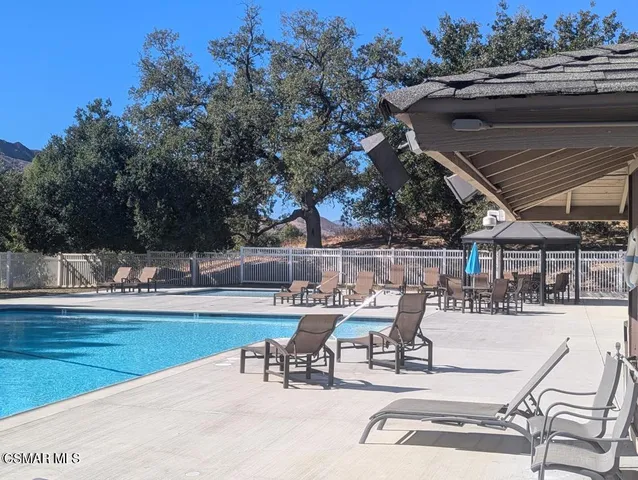 a view of a swimming pool with outdoor seating and yard