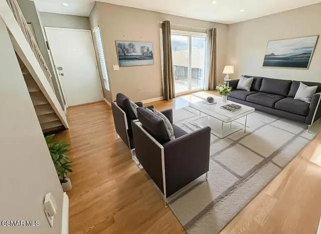 a living room with furniture and a potted plant