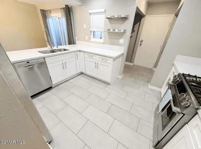 a kitchen with a sink stove and cabinets