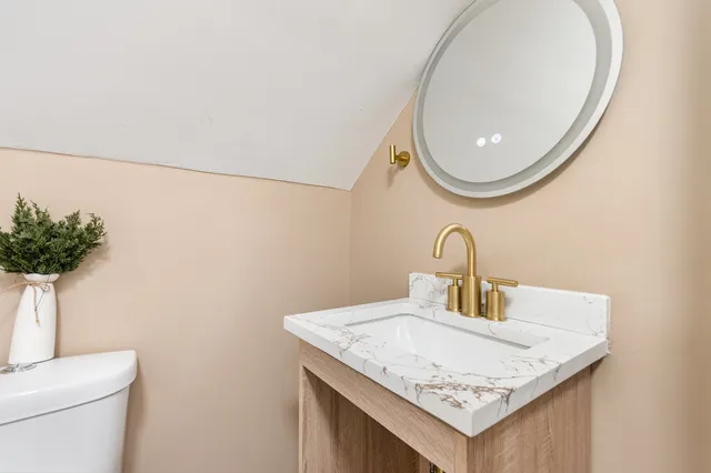 a bathroom with a sink a vanity and a mirror