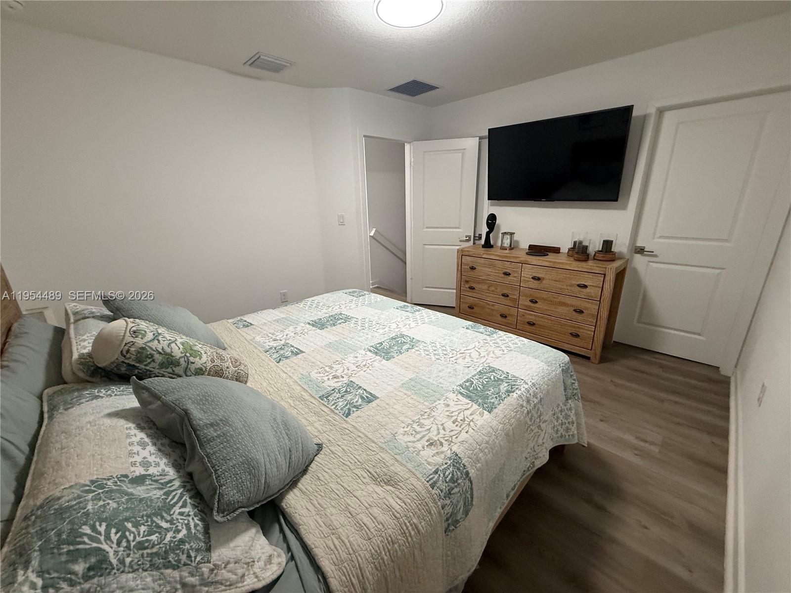 1043 Southeast 24th Avenue Homestead, FL 33035 - Photo 12 of 25 a bedroom with a bed and a flat screen tv