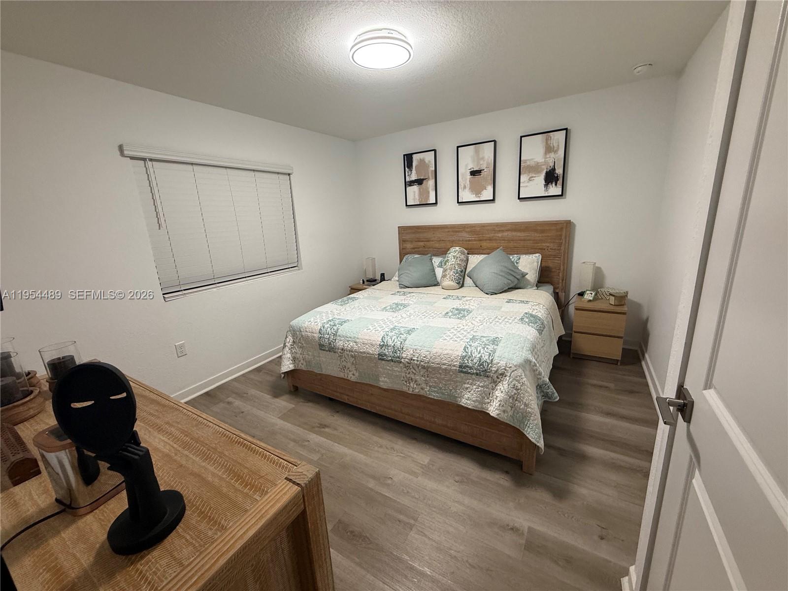 1043 Southeast 24th Avenue Homestead, FL 33035 - Photo 14 of 25 a bedroom with a bed and furniture