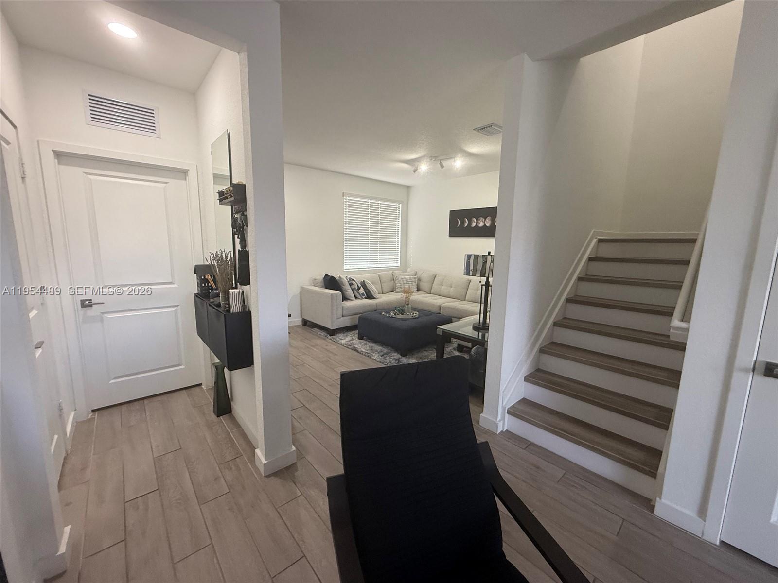 1043 Southeast 24th Avenue Homestead, FL 33035 - Photo 20 of 25 a view of a hallway with furniture and stairs