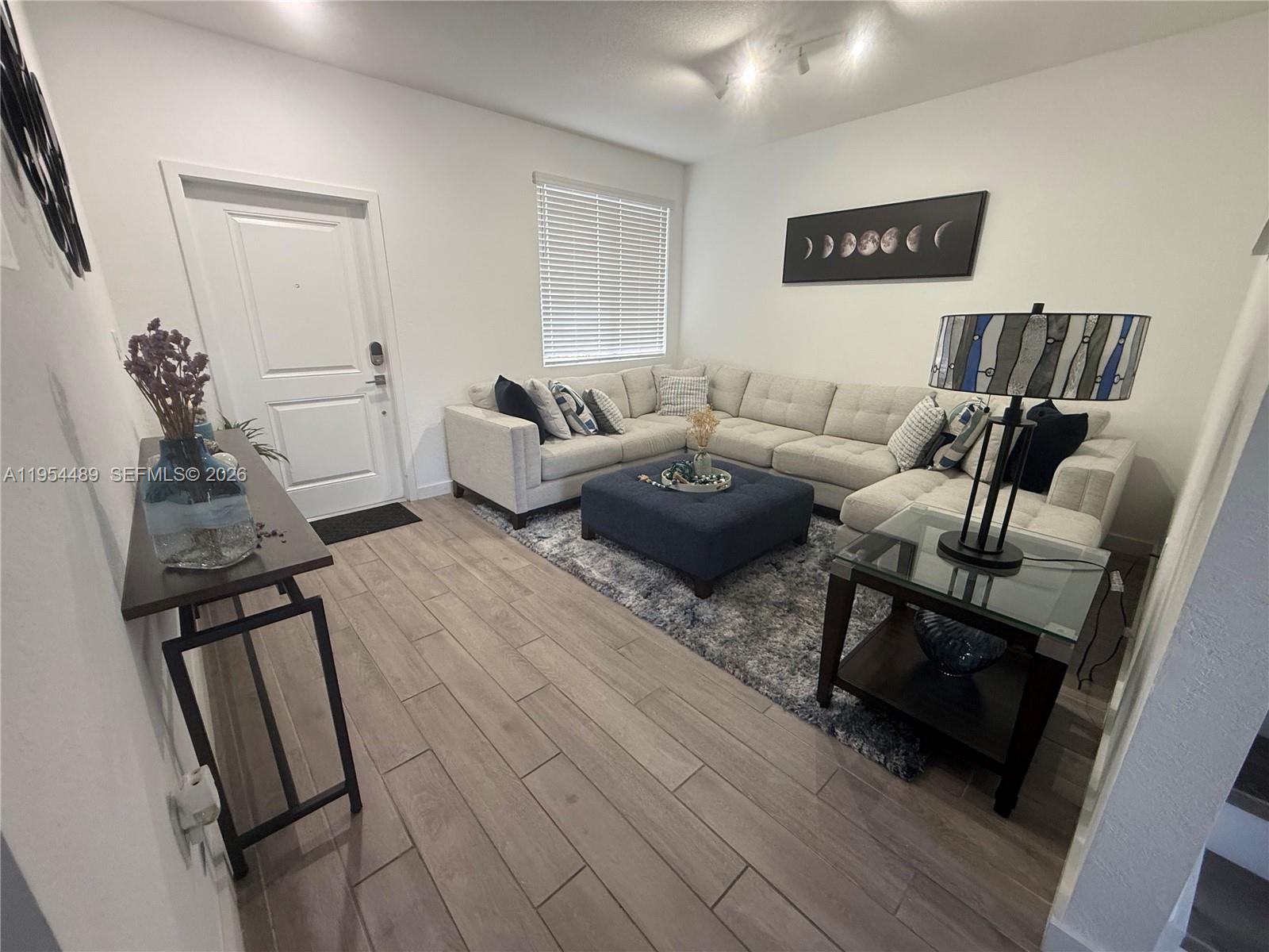 1043 Southeast 24th Avenue Homestead, FL 33035 - Photo 22 of 25 a living room with furniture and wooden floor