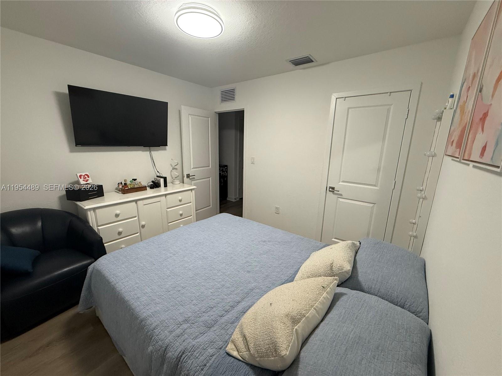 1043 Southeast 24th Avenue Homestead, FL 33035 - Photo 9 of 25 a bedroom with a bed and a flat screen tv