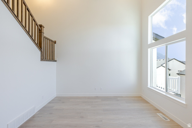 4720 Heartwood Road, Unit 438 Mapleton, UT 84664 - Photo 5 of 19 Spare room with light wood-style floors and a high ceiling