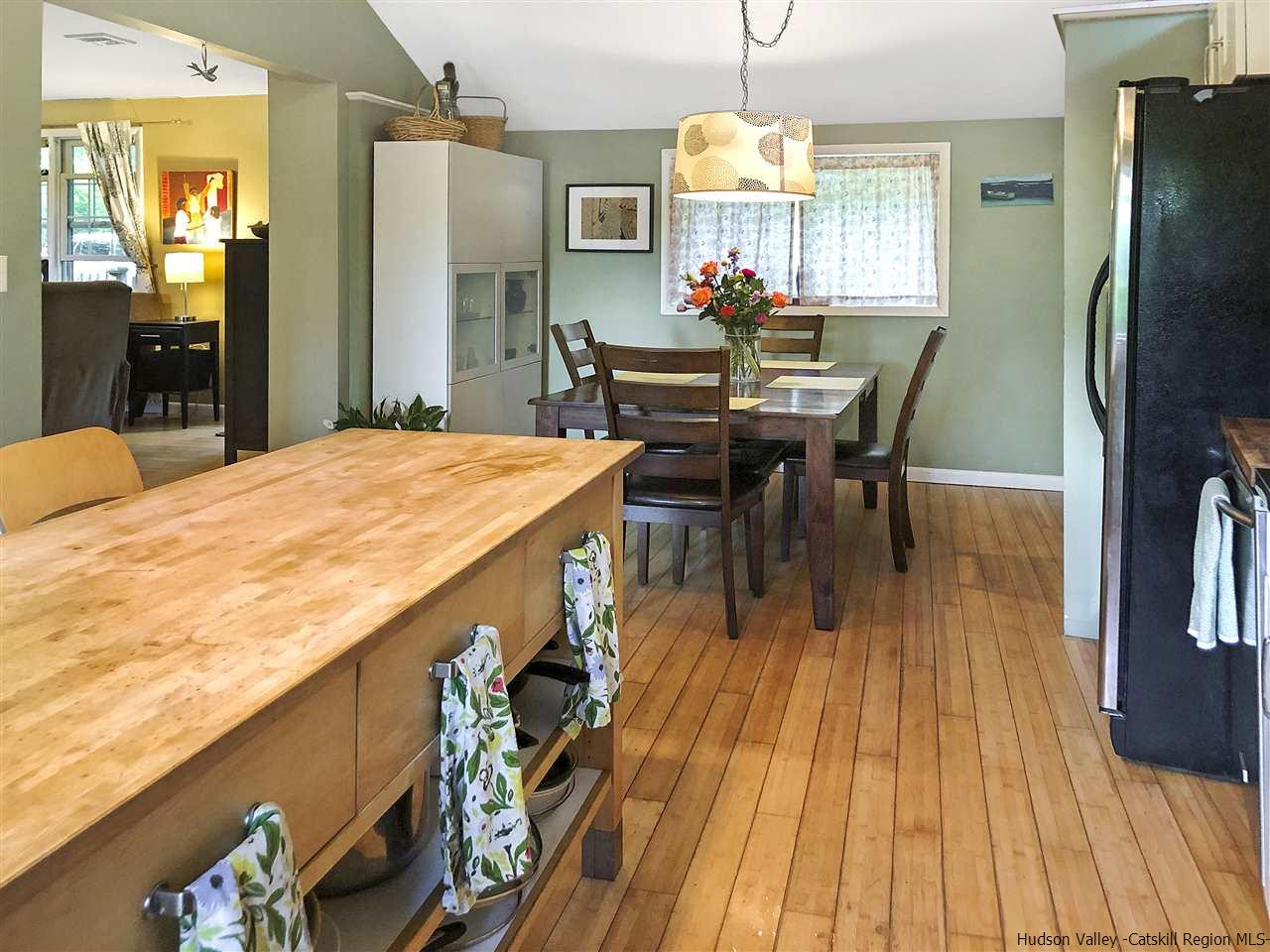 93 River Road New Paltz, NY 12561 - Photo 5 of 15 a dining room with a table chairs and a kitchen view