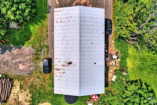 an aerial view of a house with yard swimming pool and outdoor seating