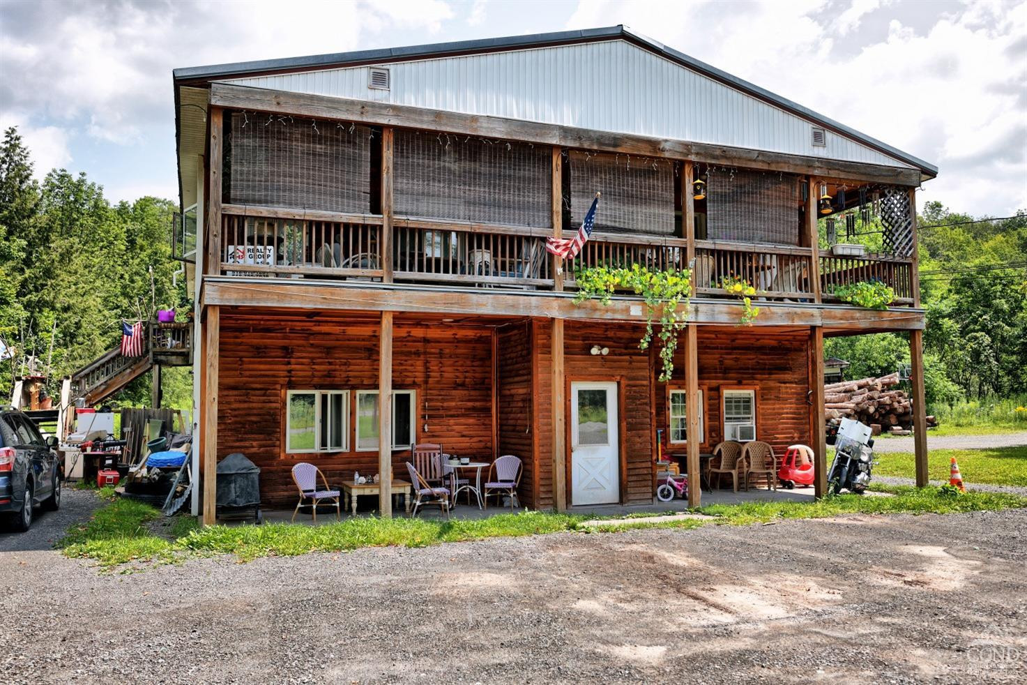 41 County Road 40 Windham, NY 12439 - Photo 28 of 36 a view of a house with a yard and table and chairs under an umbrella