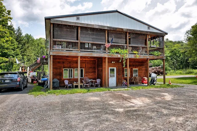 a view of a house with a yard and sitting area