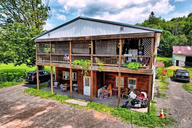 a view of a cafe with a table and chairs under an umbrella