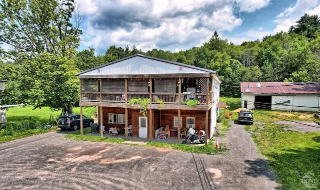 a front view of a house with a yard table and chairs