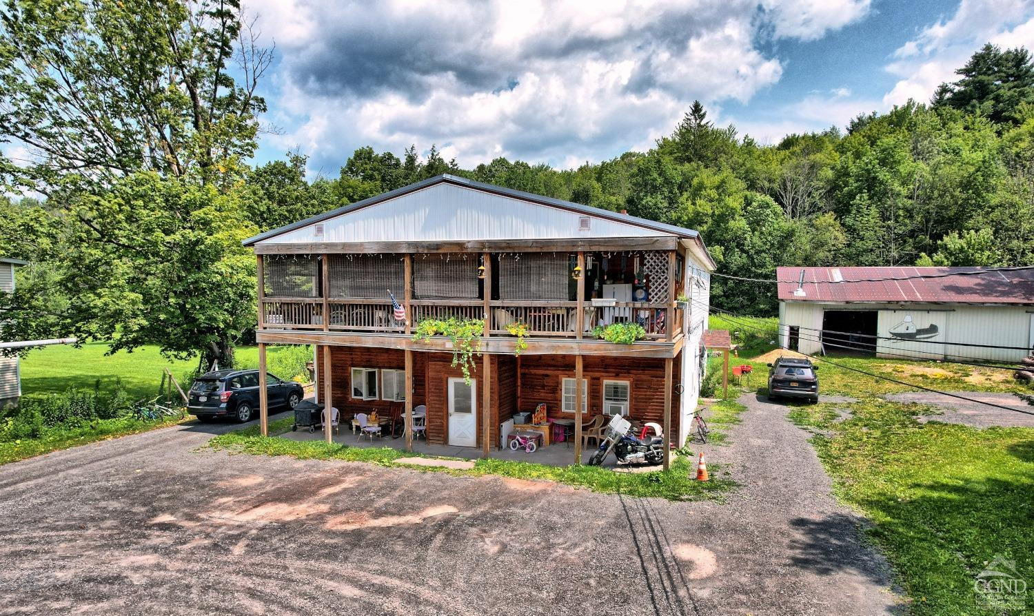 41 County Road 40 Windham, NY 12439 - Photo 4 of 36 a front view of a house with a yard table and chairs