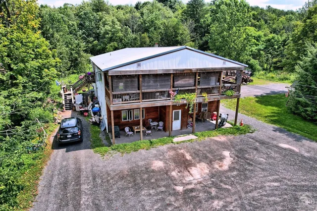 a view of a house with a yard and sitting area