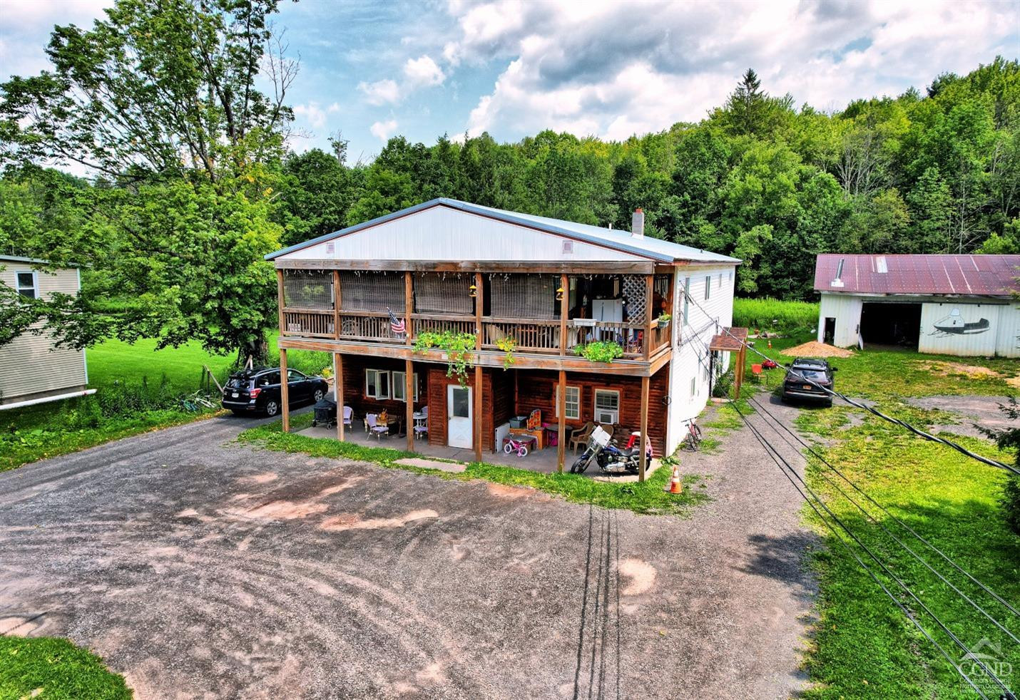 41 County Road 40 Windham, NY 12439 - Photo 6 of 36 a view of a big yard with table and chairs under an umbrella