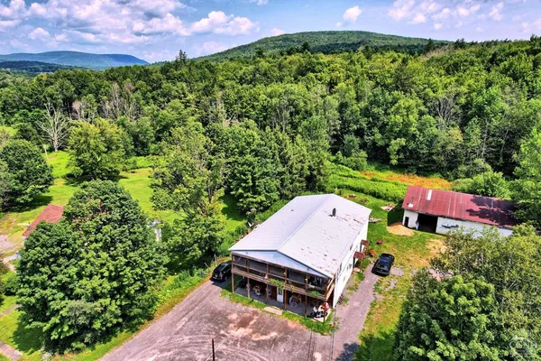 an aerial view of a house with a yard