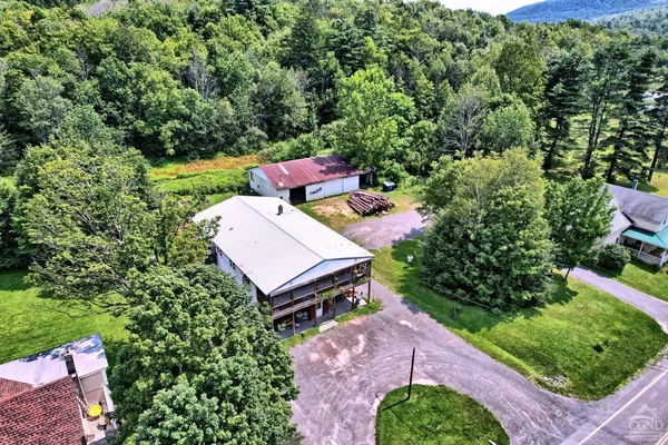 an aerial view of a house with a yard
