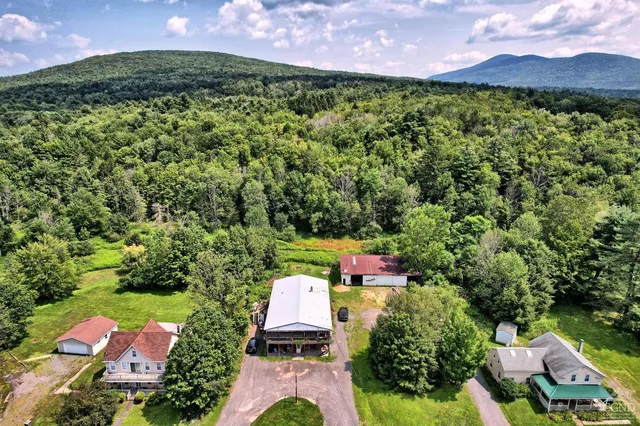 an aerial view of a houses with a yard