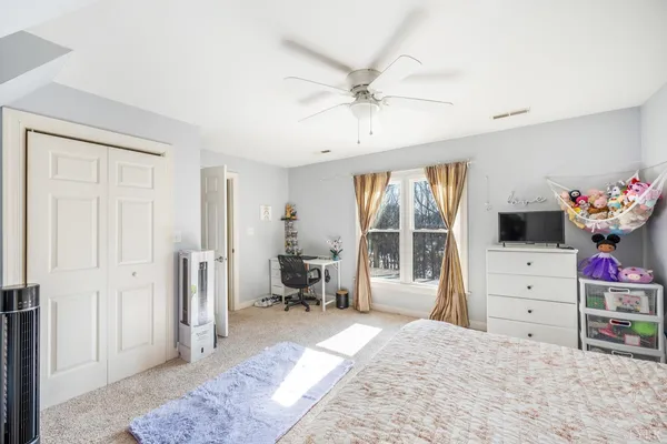 a view of a white house with a street next to a road