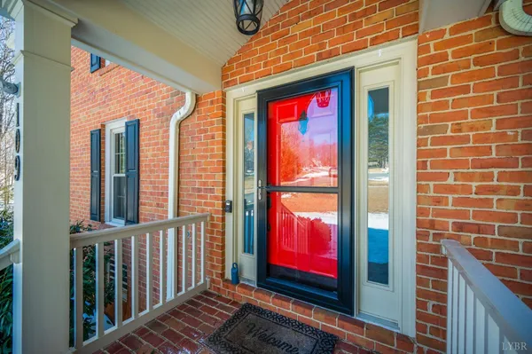 a kitchen with a table chairs microwave and cabinets
