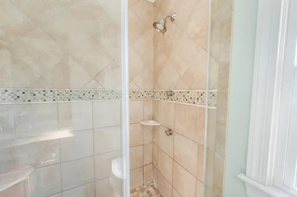 a view of a wooden house with a yard covered with snow in the background