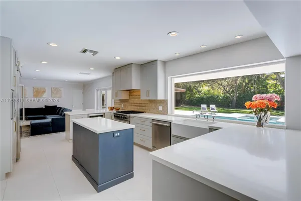 a kitchen with a stove a sink and a refrigerator