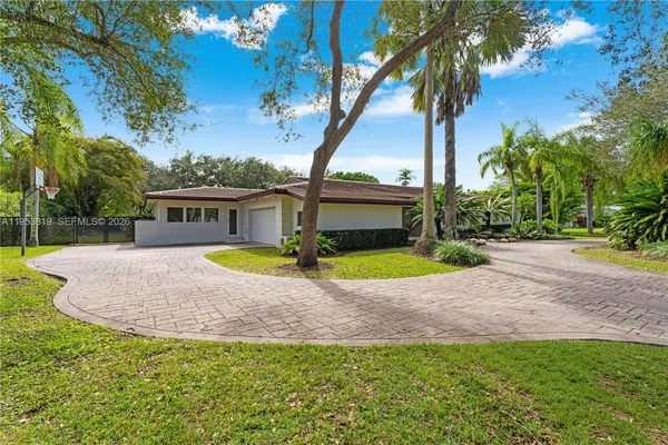 a view of a house with a backyard