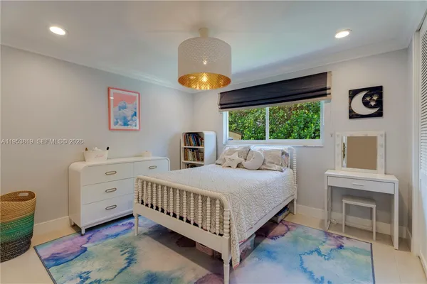 a bedroom with a bed and a book shelf