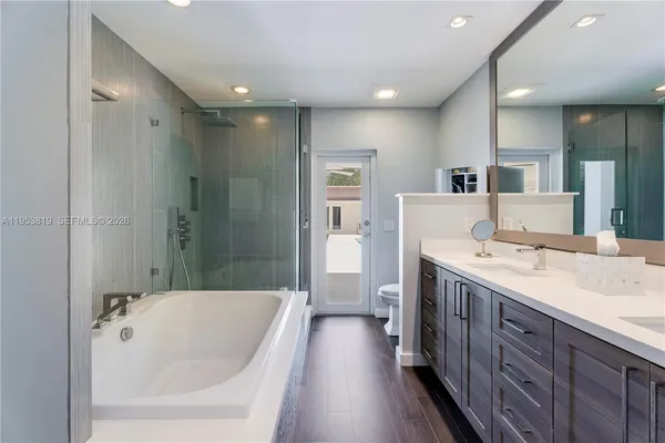 a bathroom with a tub and shower
