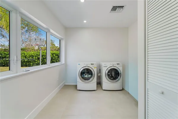 a living room with furniture lamp and window