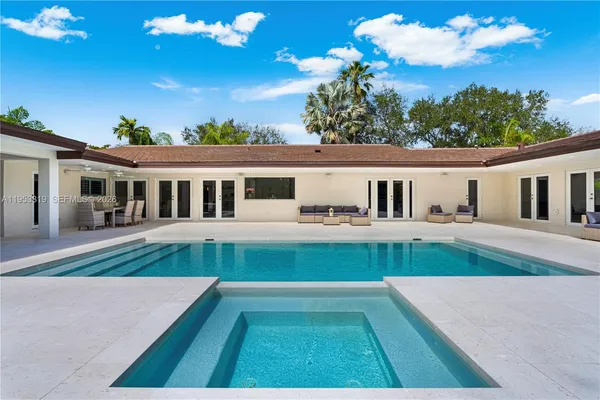a view of house with a swimming pool