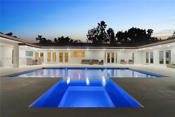 swimming pool view with a seating space