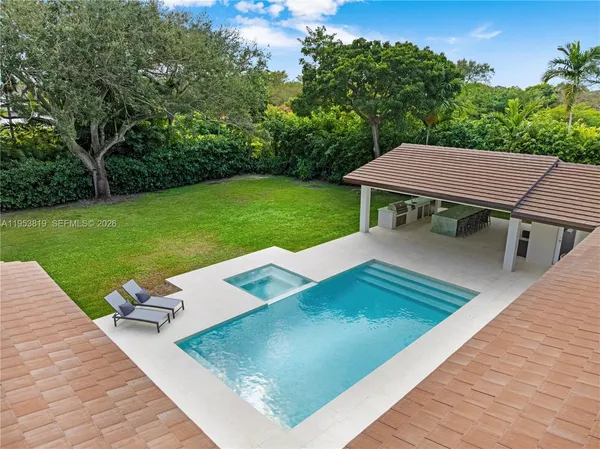 an aerial view of a house with a yard