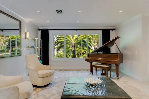 a living room with furniture and a piano