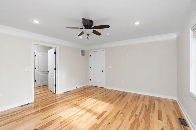 a view of empty room with wooden floor
