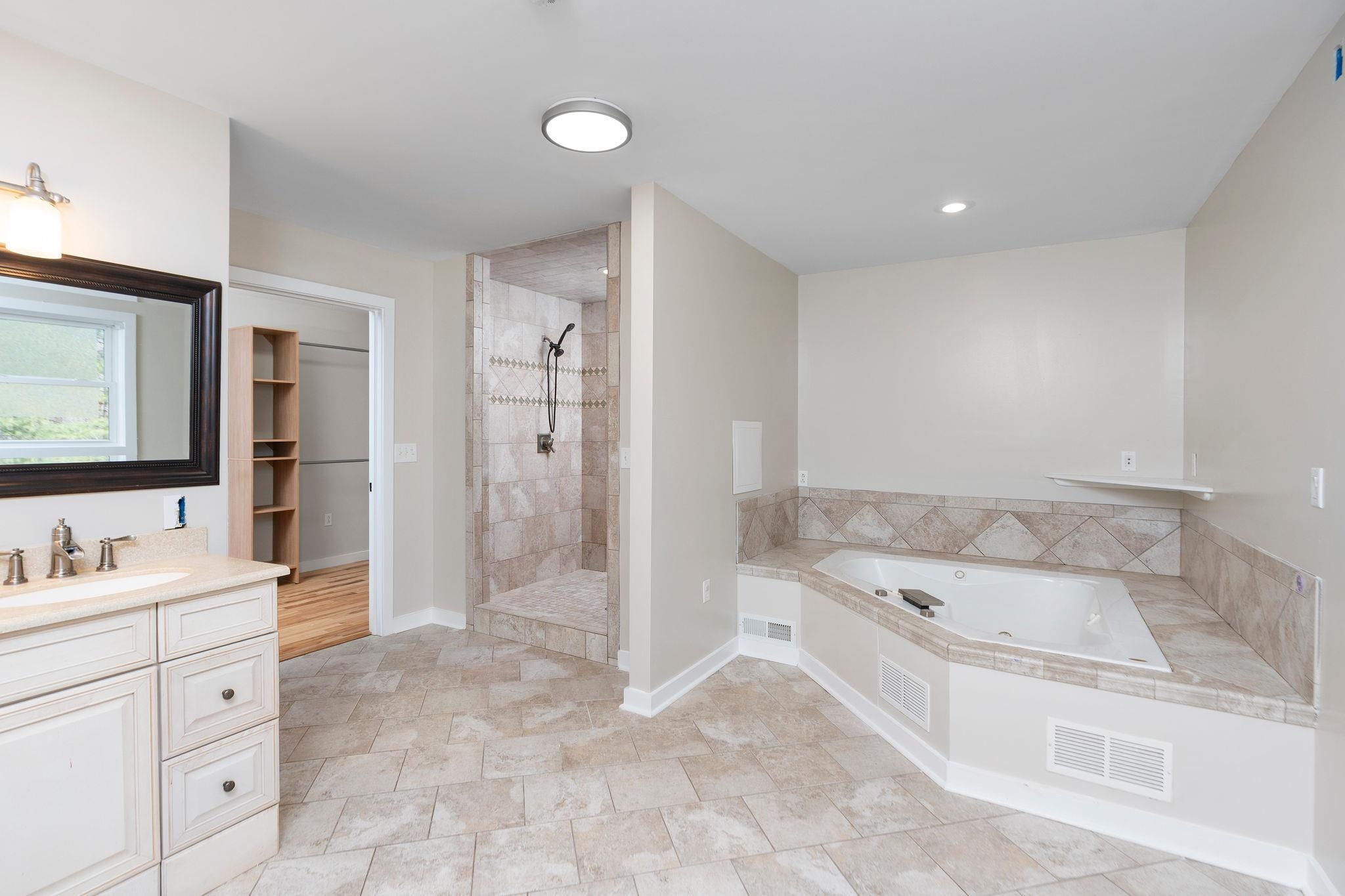 198 Turk Mountain Lane Waynesboro, VA 22980 - Photo 21 of 58 a bathroom with a tub sink and mirror