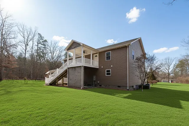 a view of a house with backyard and porch