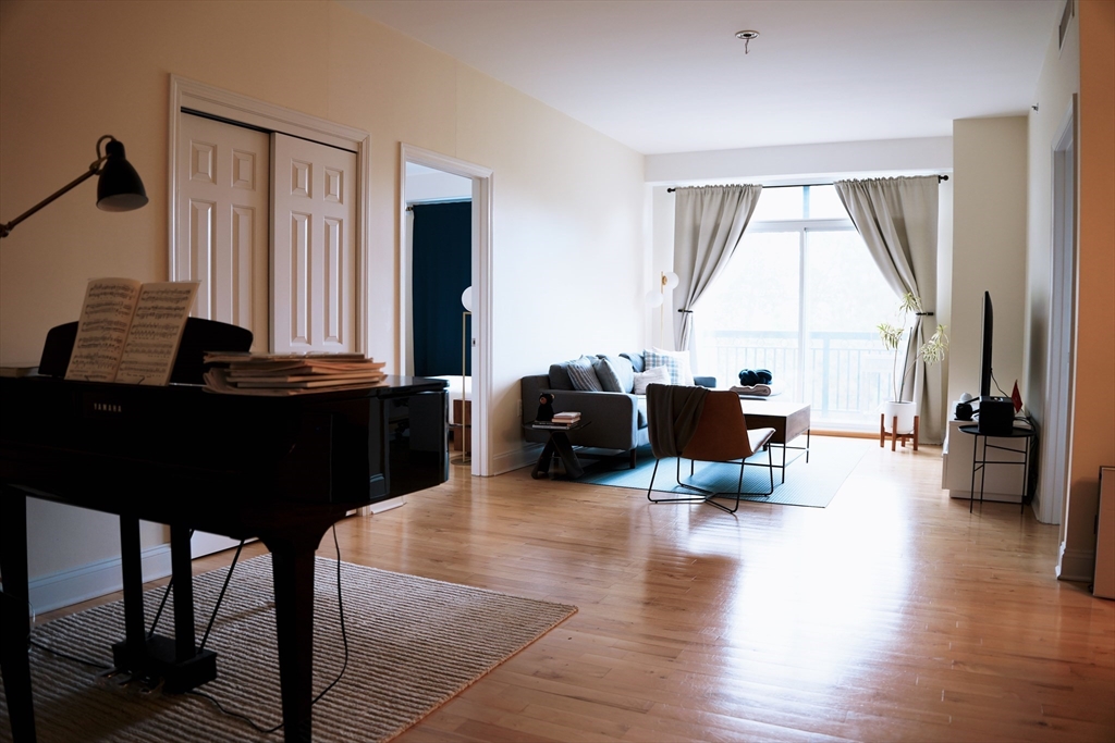 110 Cypress Street, Unit 307 Brookline, MA 02445 - Photo 1 of 24 a living room with furniture window and wooden floor