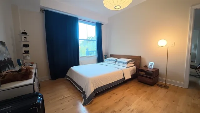 a bedroom with a bed and a window