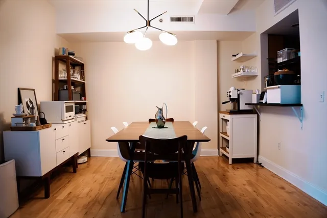 a view of a dining room with furniture and wooden floor