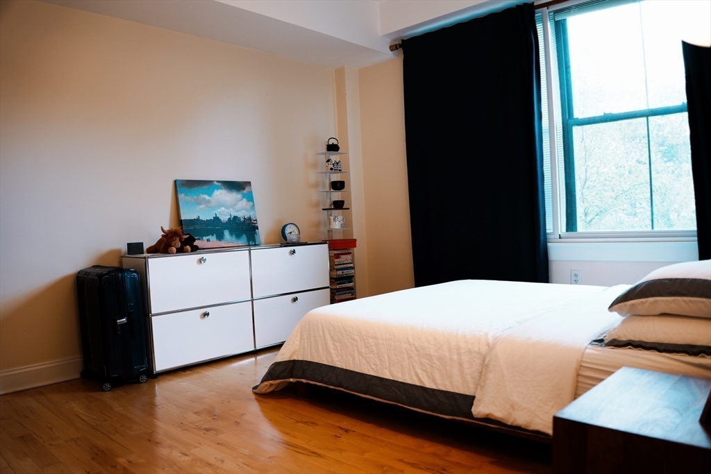 110 Cypress Street, Unit 307 Brookline, MA 02445 - Photo 9 of 24 a bedroom with a bed and a window