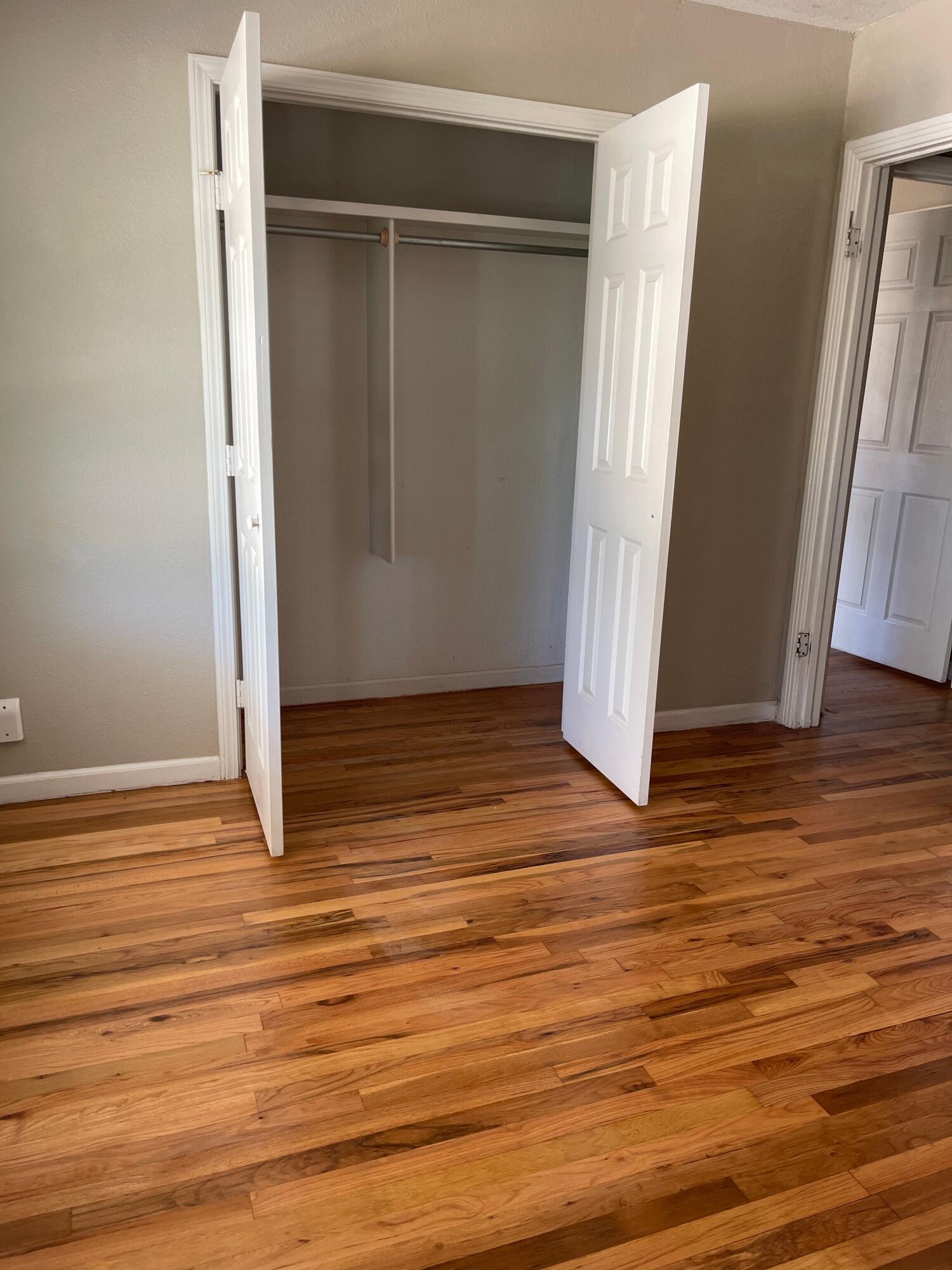 3011 32nd Street Lubbock, TX 79410 - Photo 12 of 16 an empty room with wooden floor and a window