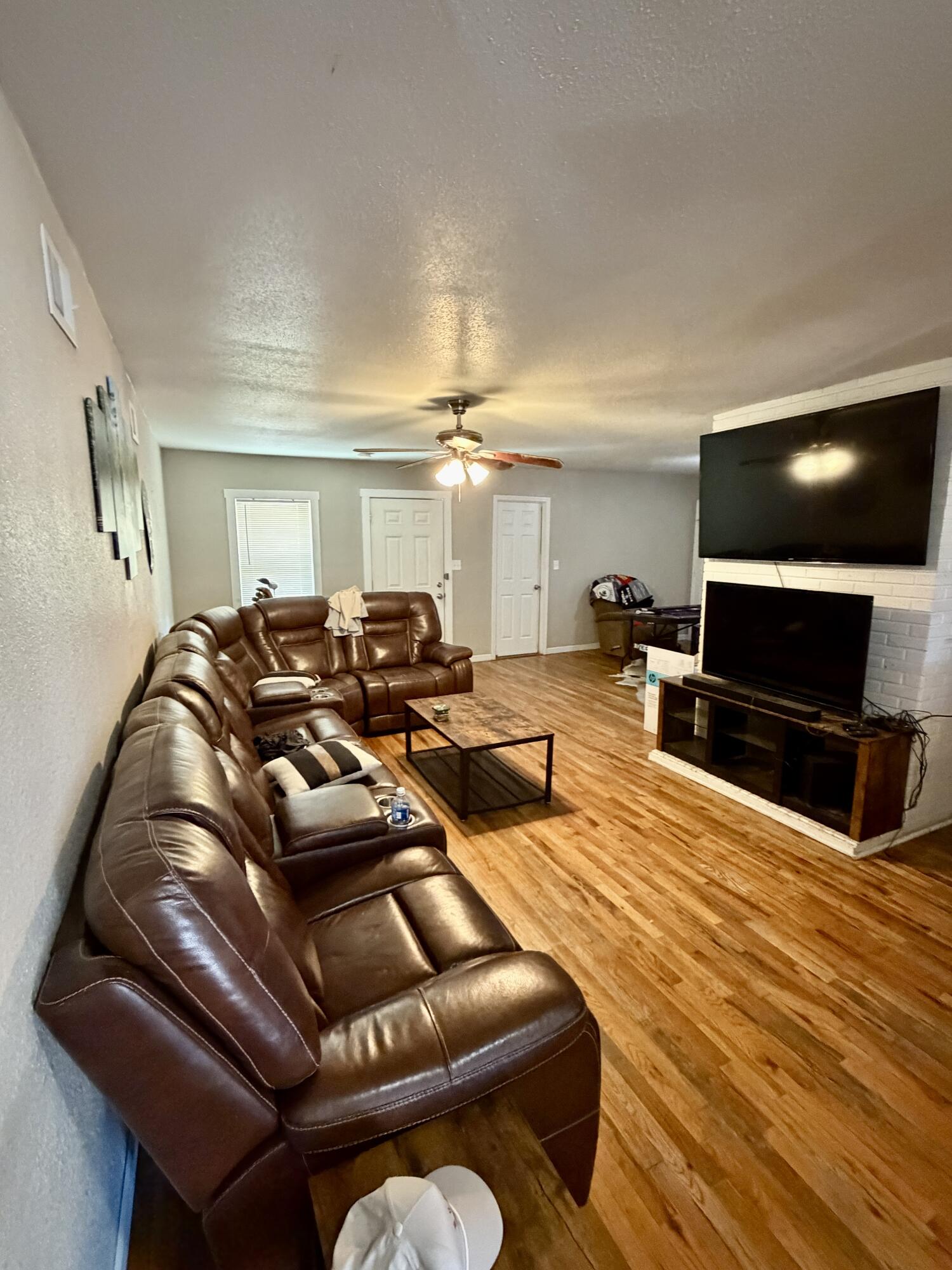 3011 32nd Street Lubbock, TX 79410 - Photo 4 of 16 a living room with furniture and a flat screen tv