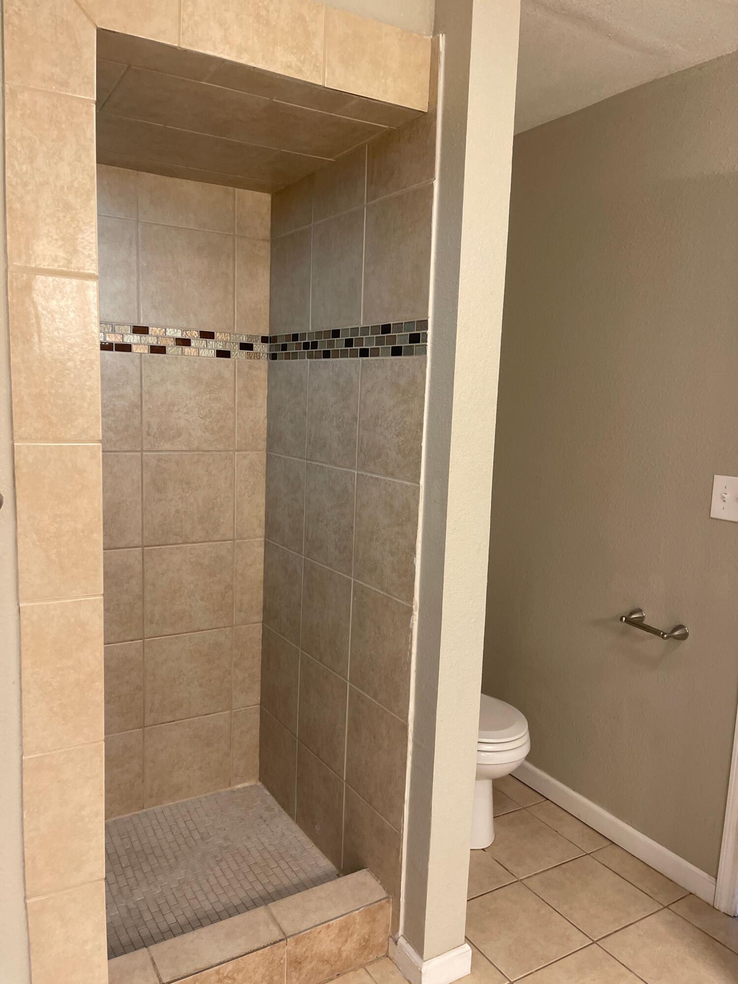 3011 32nd Street Lubbock, TX 79410 - Photo 9 of 16 a bathroom with a shower