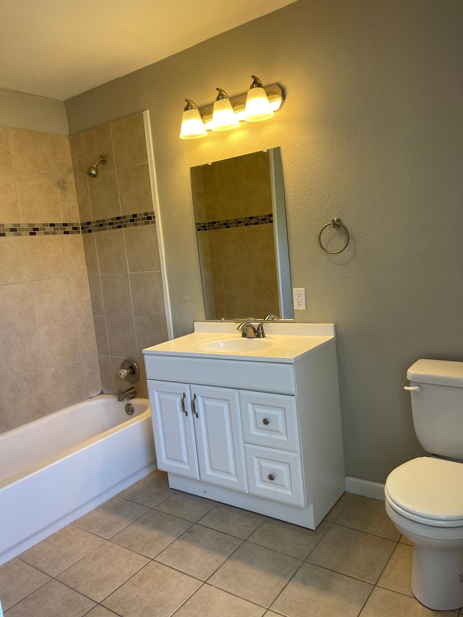 3011 32nd Street Lubbock, TX 79410 - Photo 10 of 16 a bathroom with a sink a toilet and bathtub
