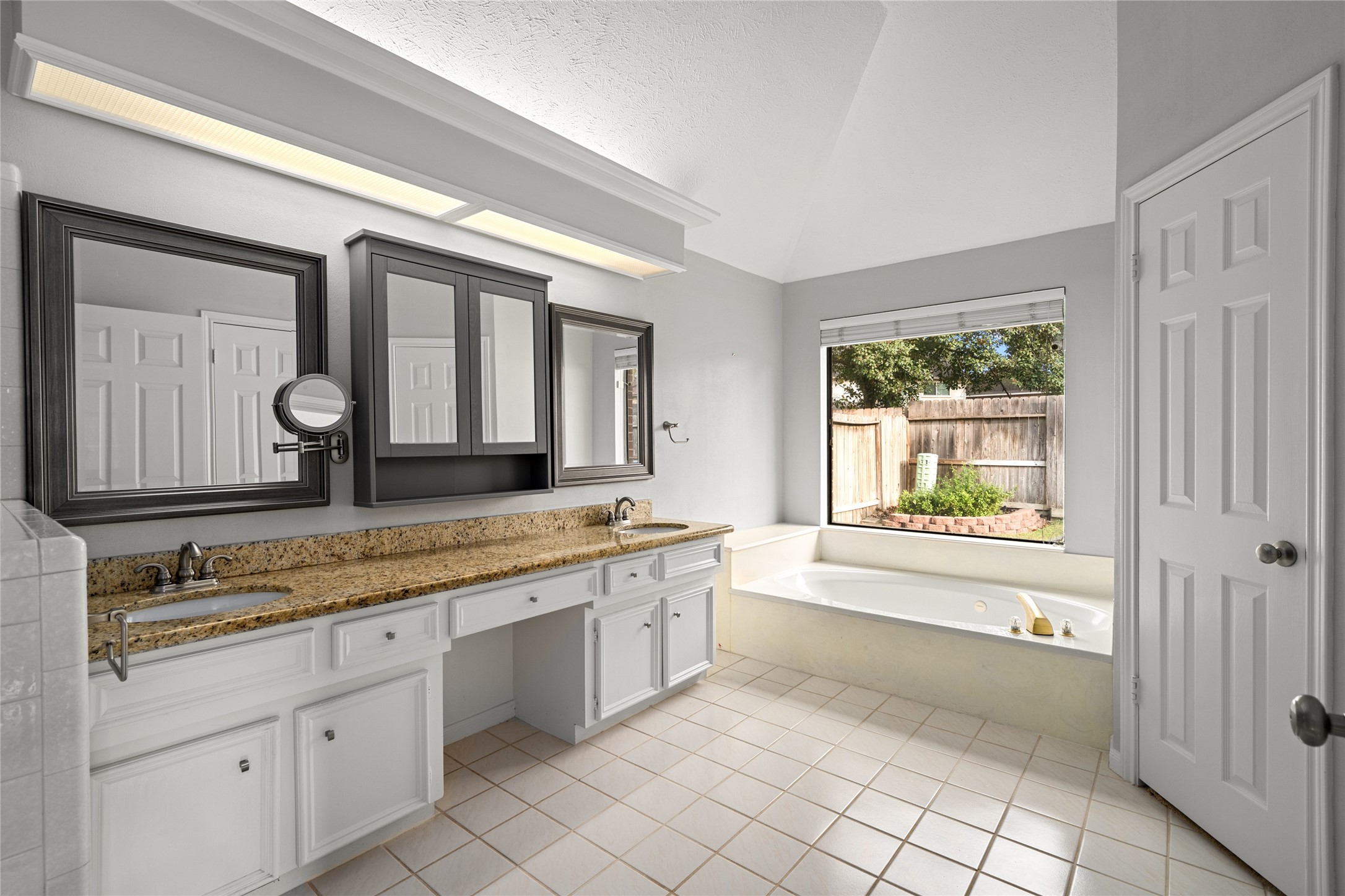 16106 Ridge Park Drive Houston, TX 77095 - Photo 18 of 23 a bathroom with a granite countertop sink mirror and a bathtub