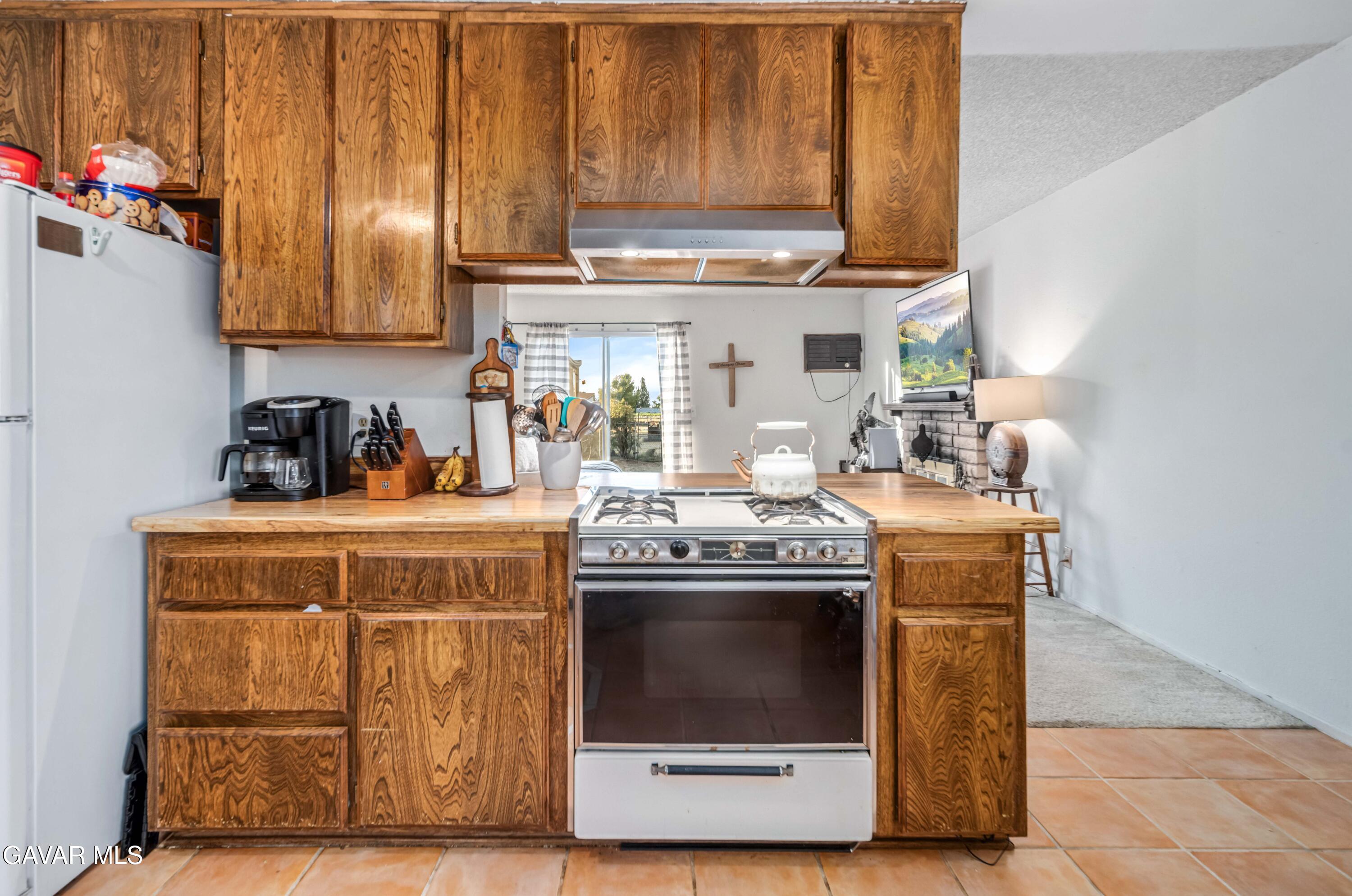 20539 East Ave R Palmdale, CA 93591 - Photo 23 of 55 a kitchen with stainless steel appliances granite countertop a stove and a microwave