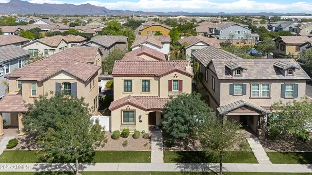 an aerial view of a house with outdoor space pool patio and lake view