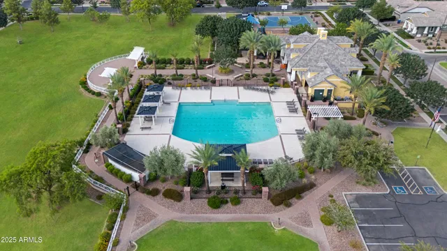 an aerial view of residential houses with outdoor space and trees