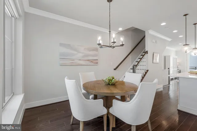 a view of a dining room with furniture wooden floor and chandelier